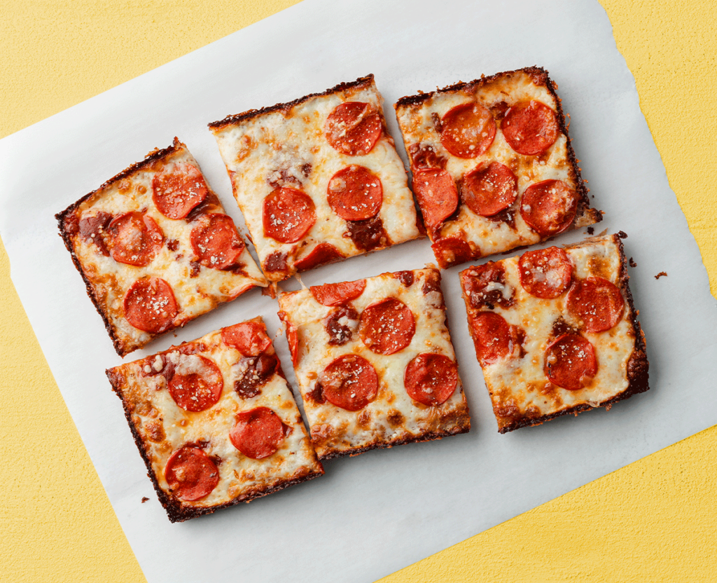Detroit-style pepperoni pizza cut into squares