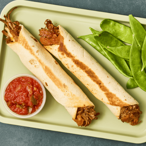 Turkey Barbacoa flautas on a green lunch tray