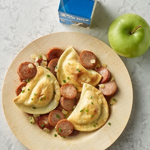 Kielbasa pierogi bowl with a green apple on the side